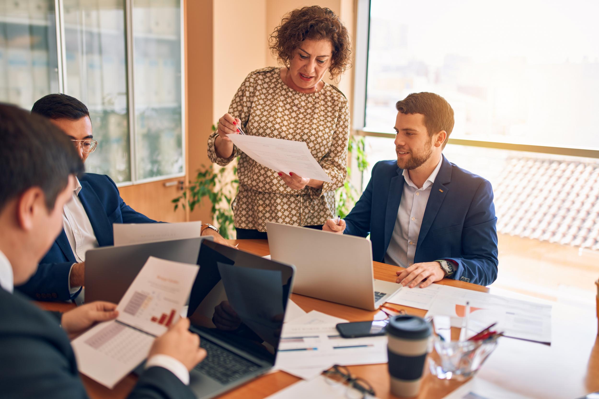 a female and male attorney review papers in a conference room